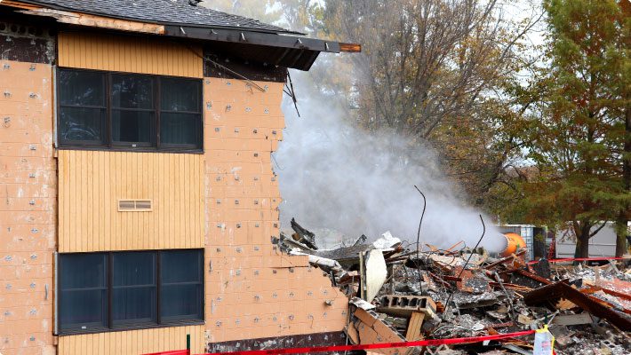 Demolition with dust cannon over materials