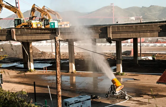 Doyle Drive demolition using misting cannon to control dust on Golden Gate bridge route near Presidio