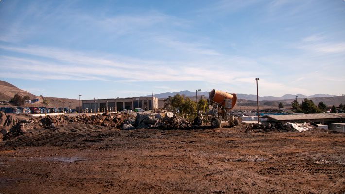 Recycled asphalt and concrete site with dust control cannon