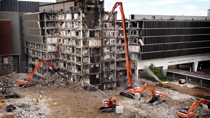 Colorado cleanup demolition site with excavators and dust cannons