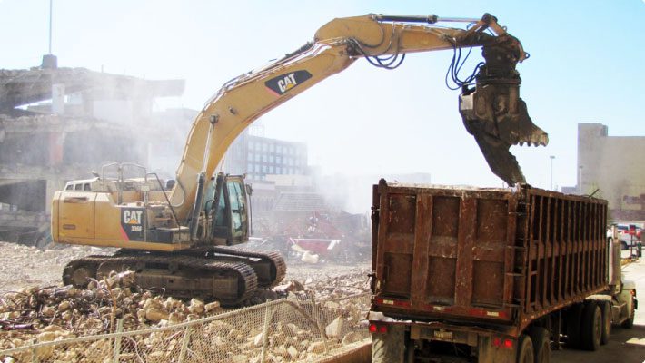 Crane loading wire at demolition site