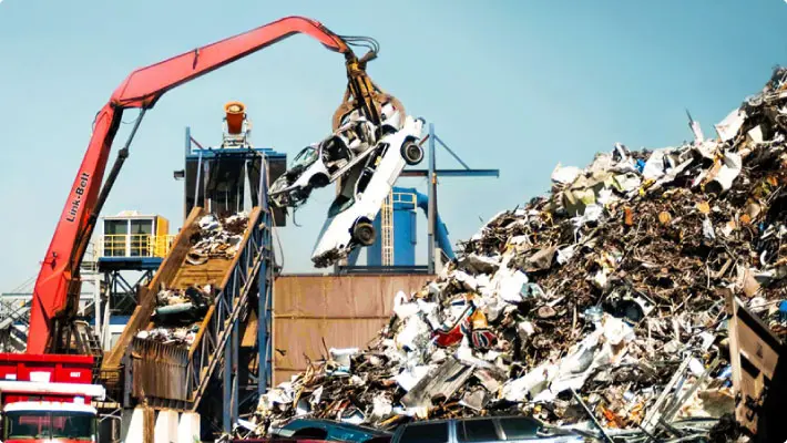 Scrap yard unloading and loading cars with dust control system above