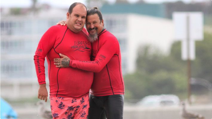 Izzy-and-his-son-Isaiah-on-the-beach-Surfers-Healing